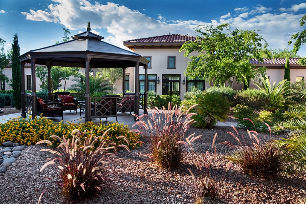 Outdoor patio furniture under a gazebo in the gardens at Las Ventanas