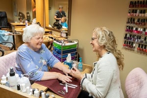 Senior woman getting a manicure in the salon at Las Ventanas