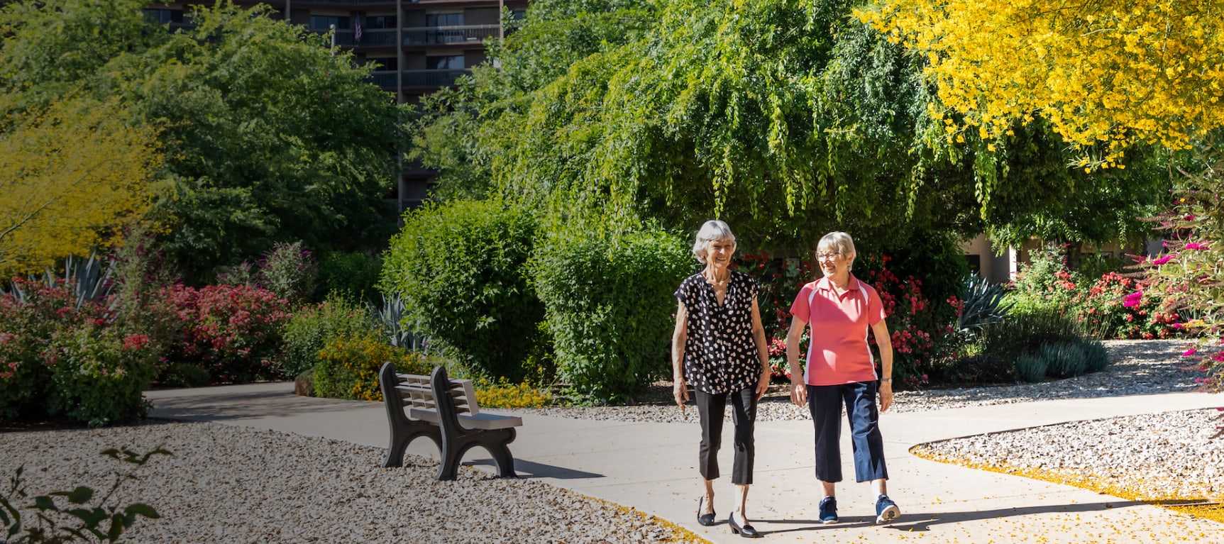 Two women walking down an outdoor path