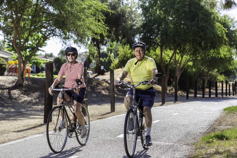 Man and woman riding their bikes along a path