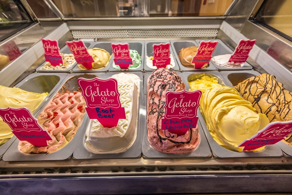 A dessert case filled with flavors of gelato