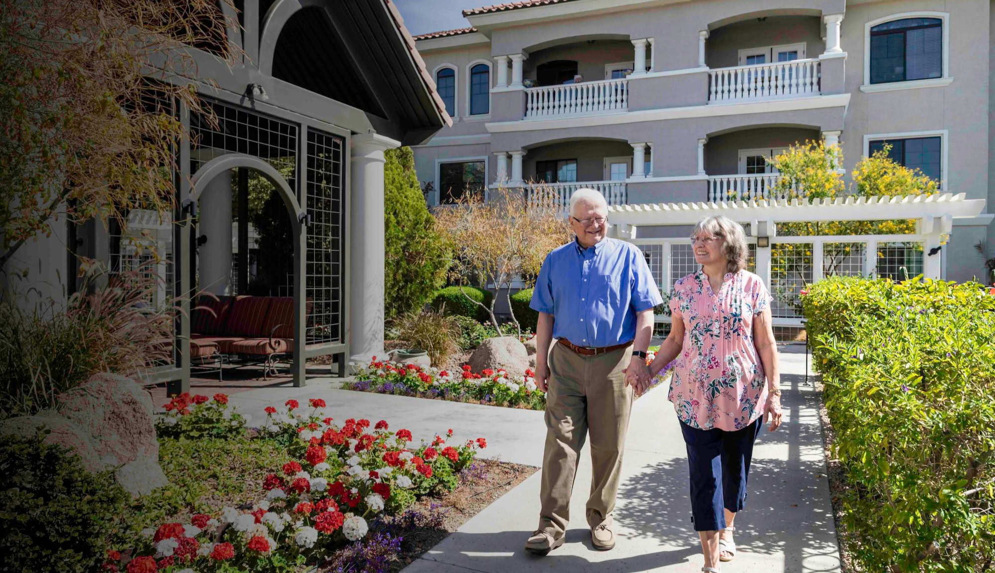 Man and woman walking down a garden path