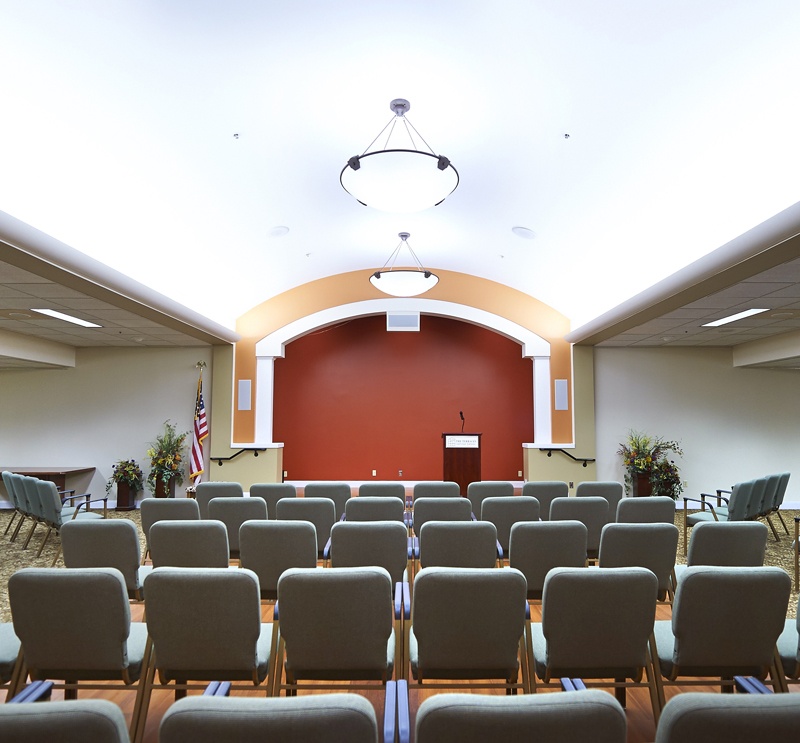Auditorium with a podium and rows of chairs