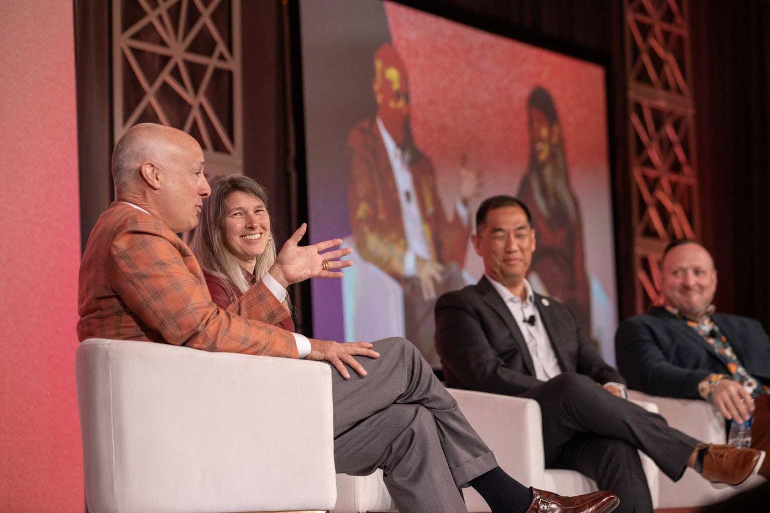 Four people sitting on stage