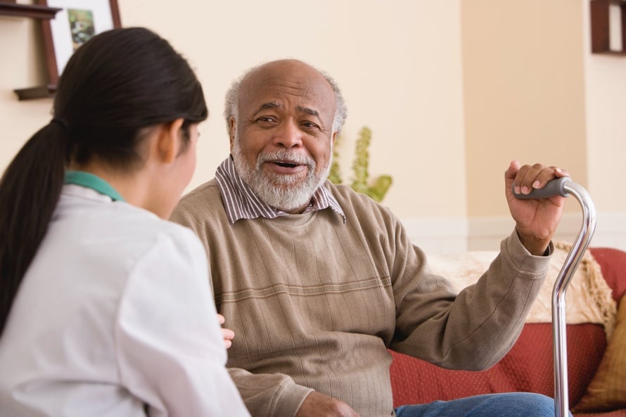 man with cane talking to medical provider