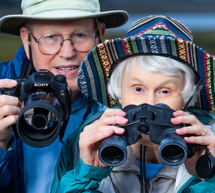 Bryce and Ann holding binoculars