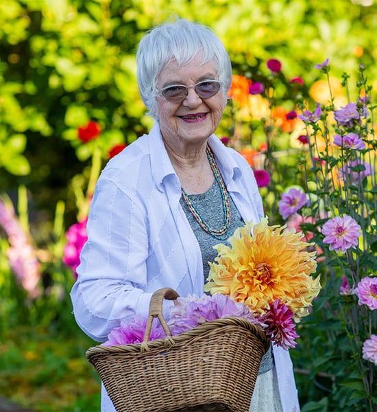 Doris holding a basket of fresh cut flowers