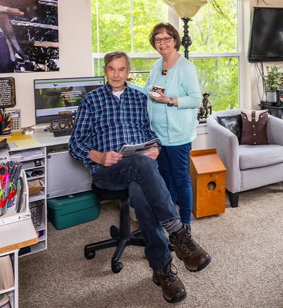 senior couple posing in home office