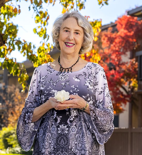 Donna, a senior woman, holding a flower