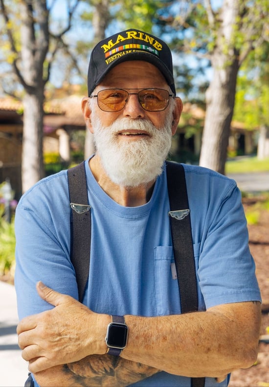 Dan with his marine hat and wearing a blue shirt.