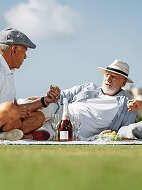 Two senior men having a picnic