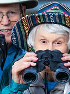 Senior woman looking through binoculars