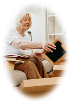 Senior woman packing a picture frame in a moving box