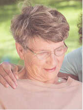 Woman with an arm around her shoulder