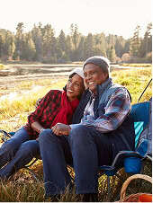 Man and woman sitting on a bench outdoors