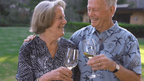 Senior couple enjoying a glass of white wine