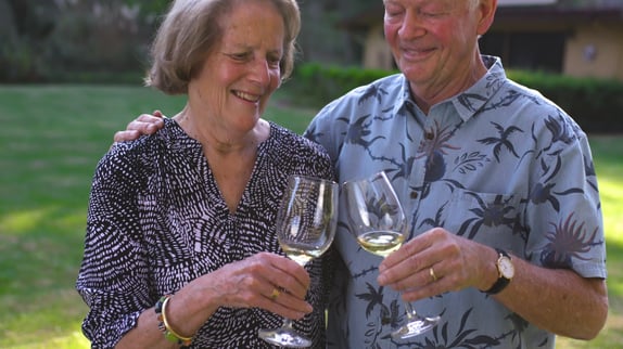 Senior couple toasting their wine glasses