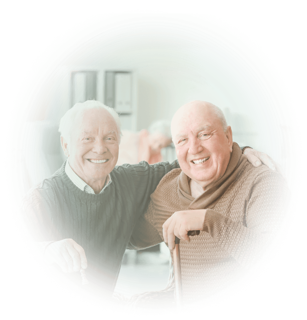 Two smiling senior men with their arms around each others' shoulders