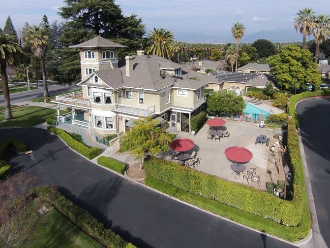 Multi-story house with outdoor patio and pool.