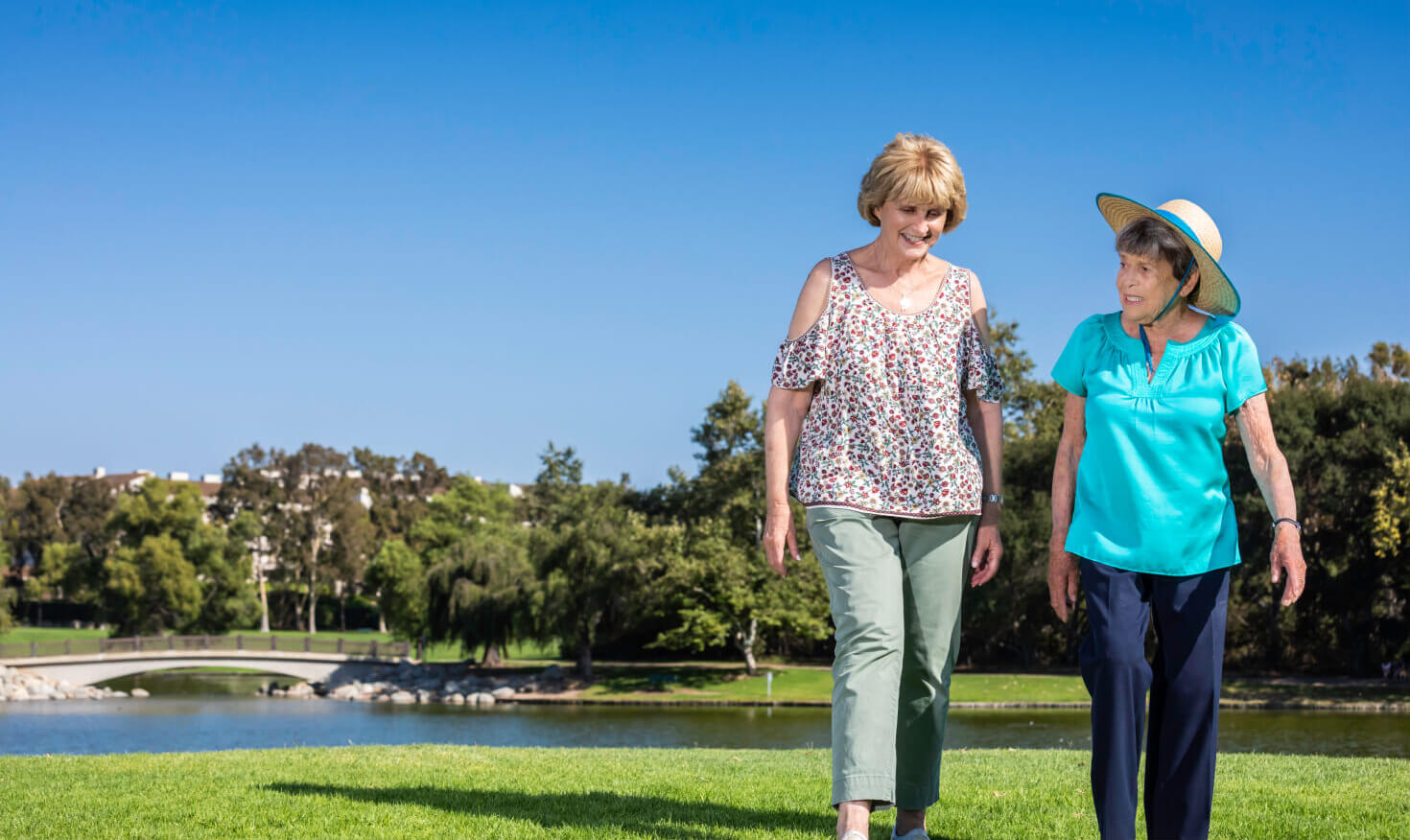 Two senior women walking through a park at Regents Point