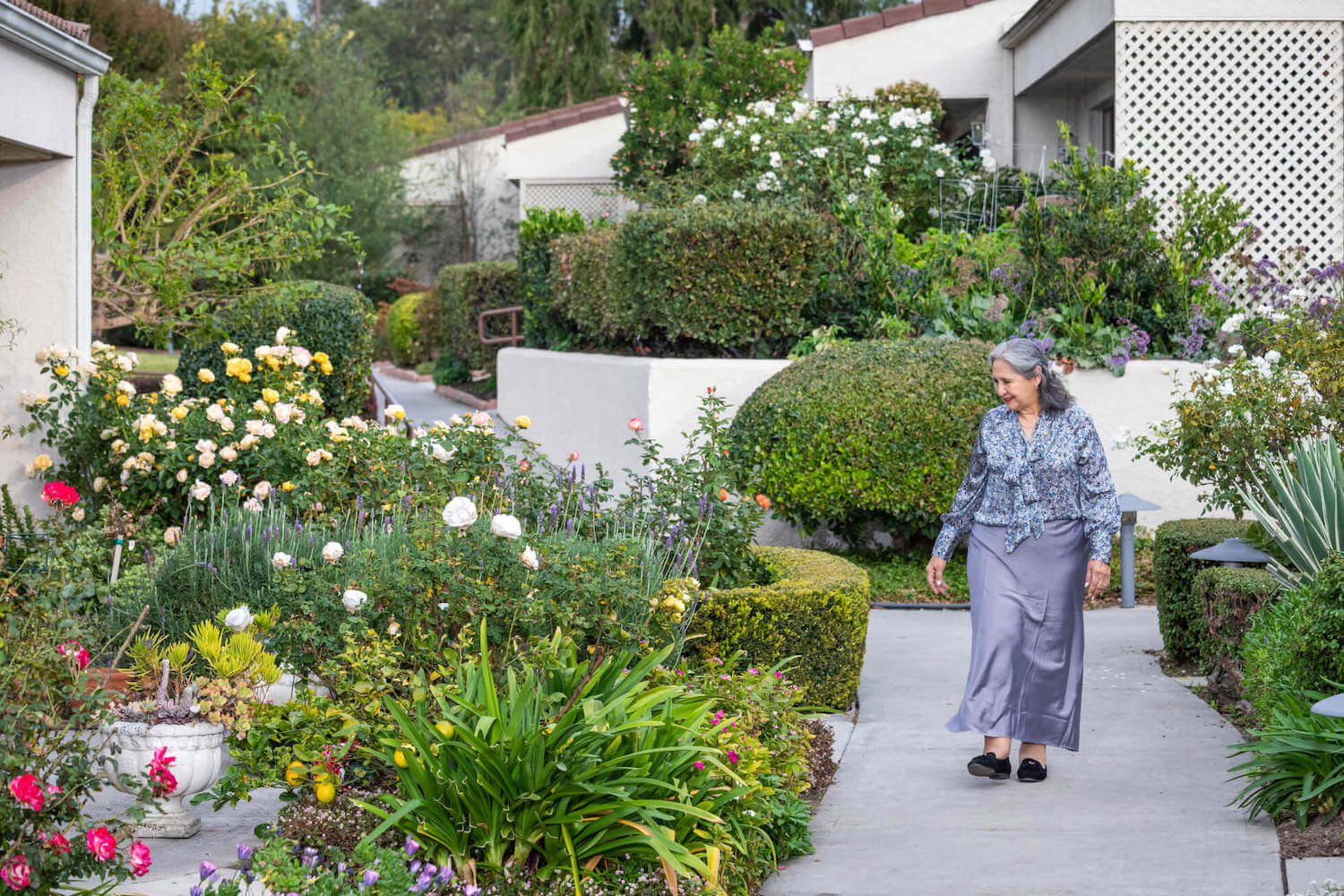 Senior woman walking through an outdoor garden