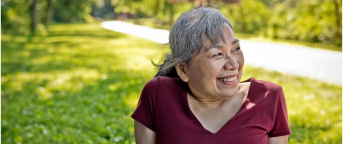 smiling senior woman sitting outside