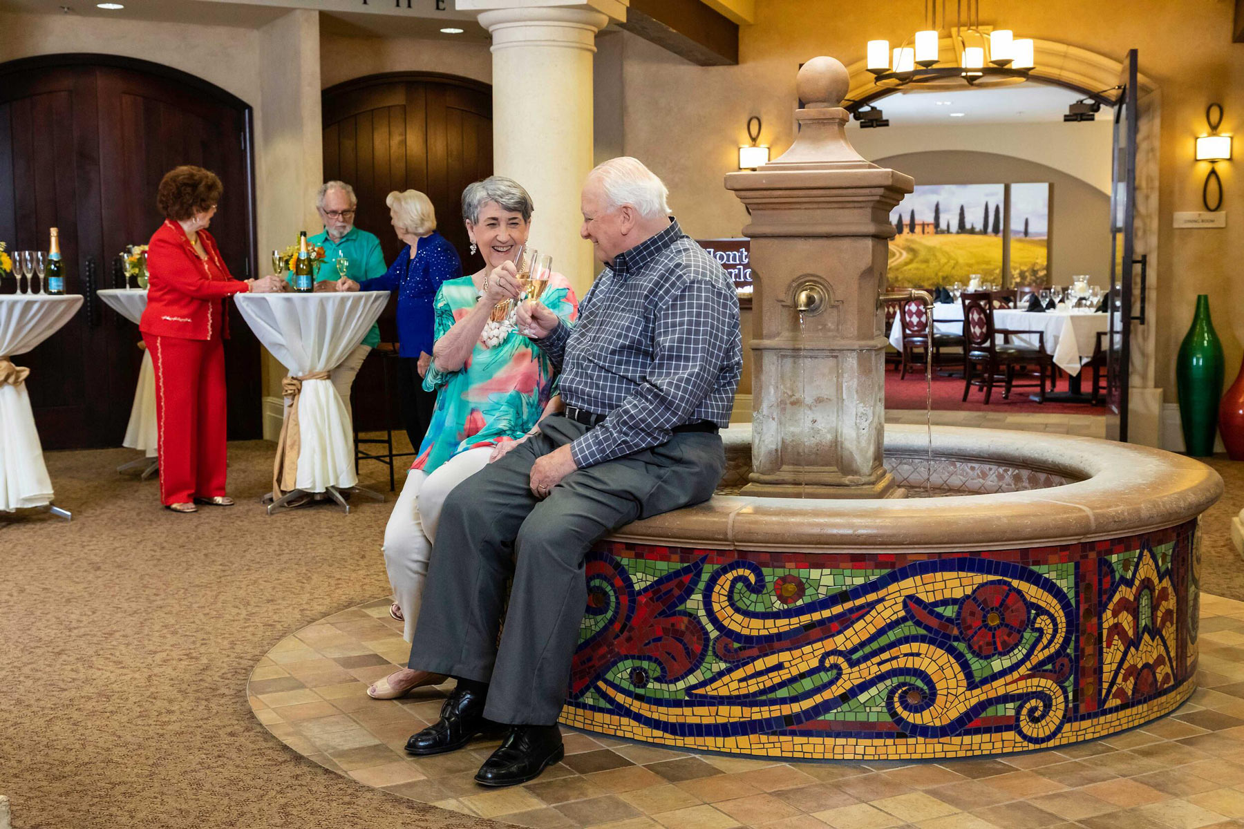 couple toasting near an indoor fountain