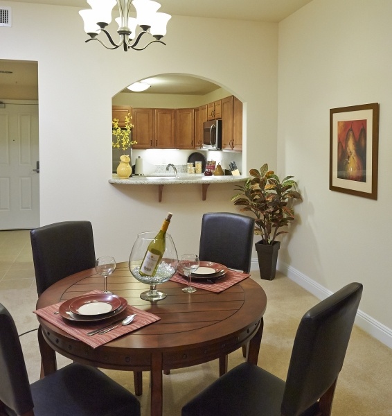 Dining room and kitchen of an apartment at The Terraces at San Joaquin Gardens