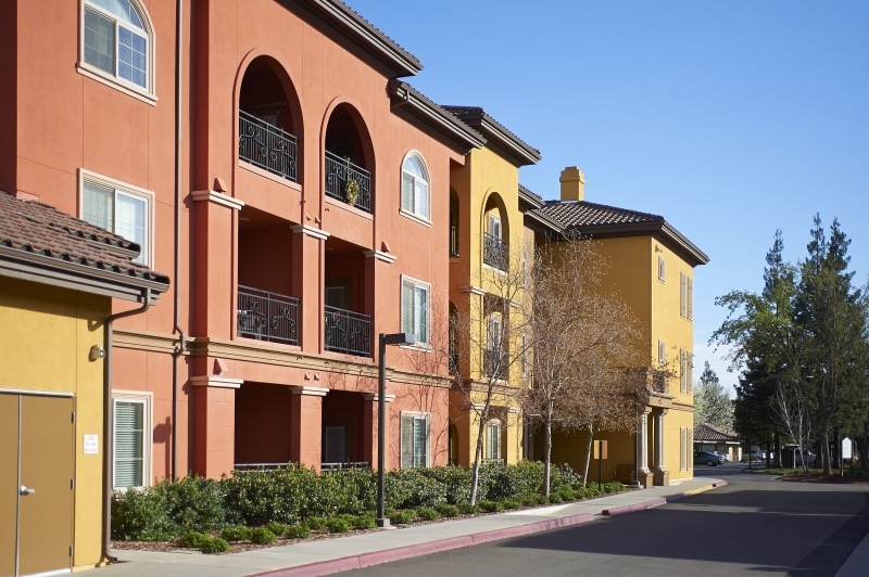  Colorful orange and yellow exterior of apartment buildings at The Terraces at San Joaquin Gardens