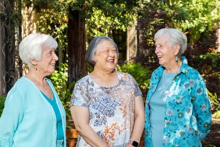 Three senior women having a conversation outside