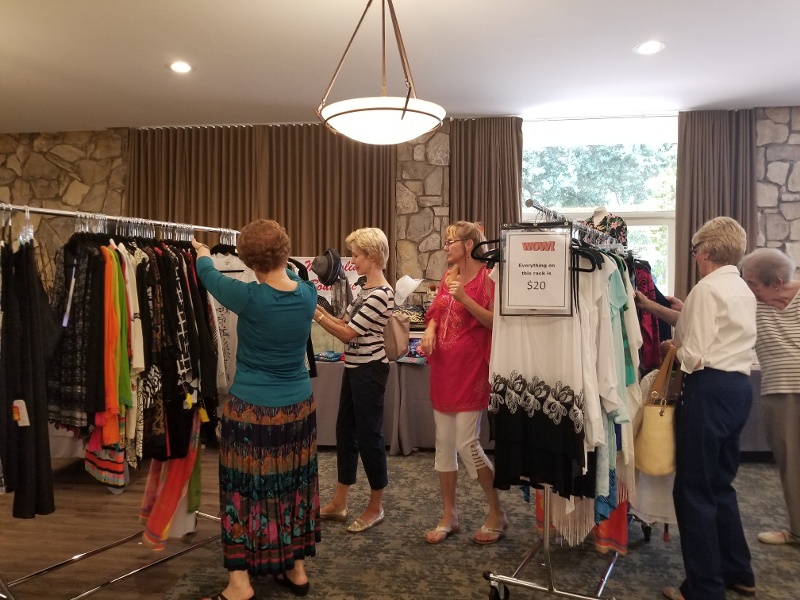 Royal Oaks residents going through racks of clothes for sale.