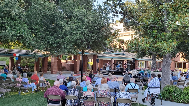 Residents watching an outdoor concert.
