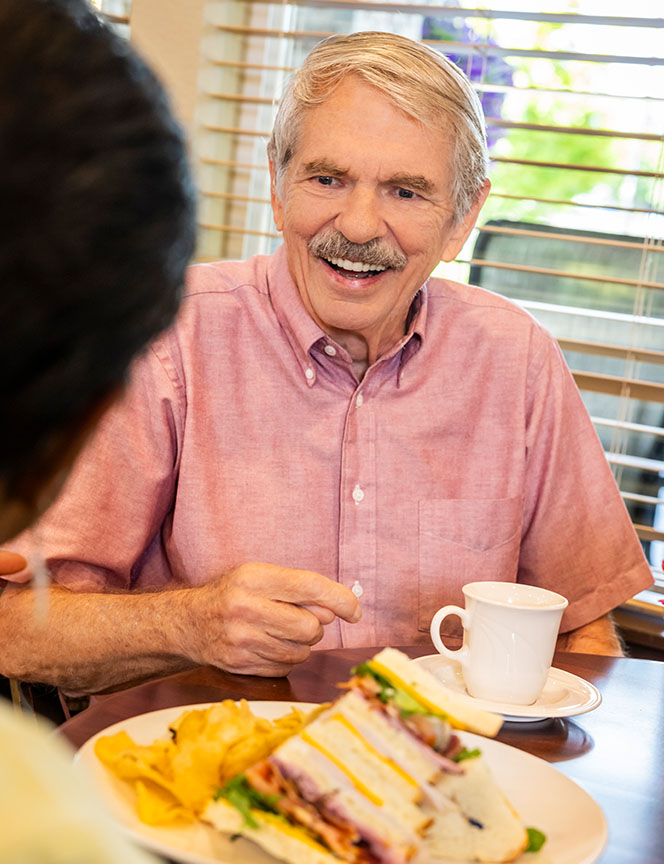 senior man enjoying lunch at a bistro