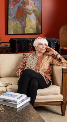  Senior woman sitting on a couch in living room