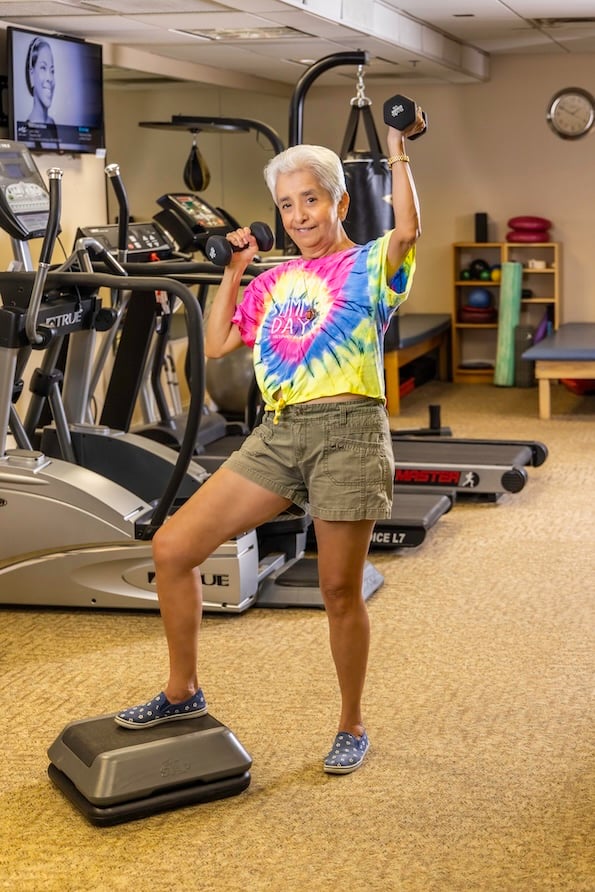 Marti holding weights in the gym