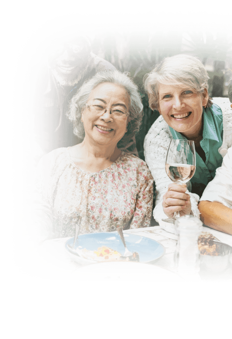 senior friends enjoying lunch with wine