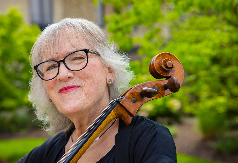 senior posing with a cello