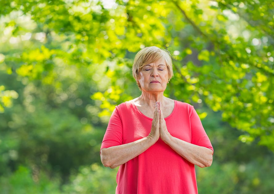 Senior woman outside doing yoga