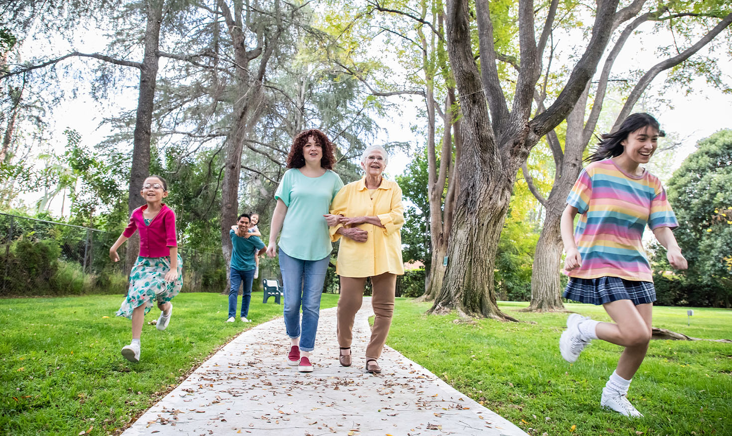 Senior woman walking with her grandkids on the grounds of Westminster Gardens