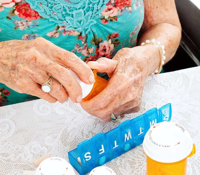 Woman opening a prescription pill bottle