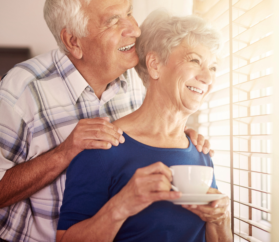 couple smiling looking out window