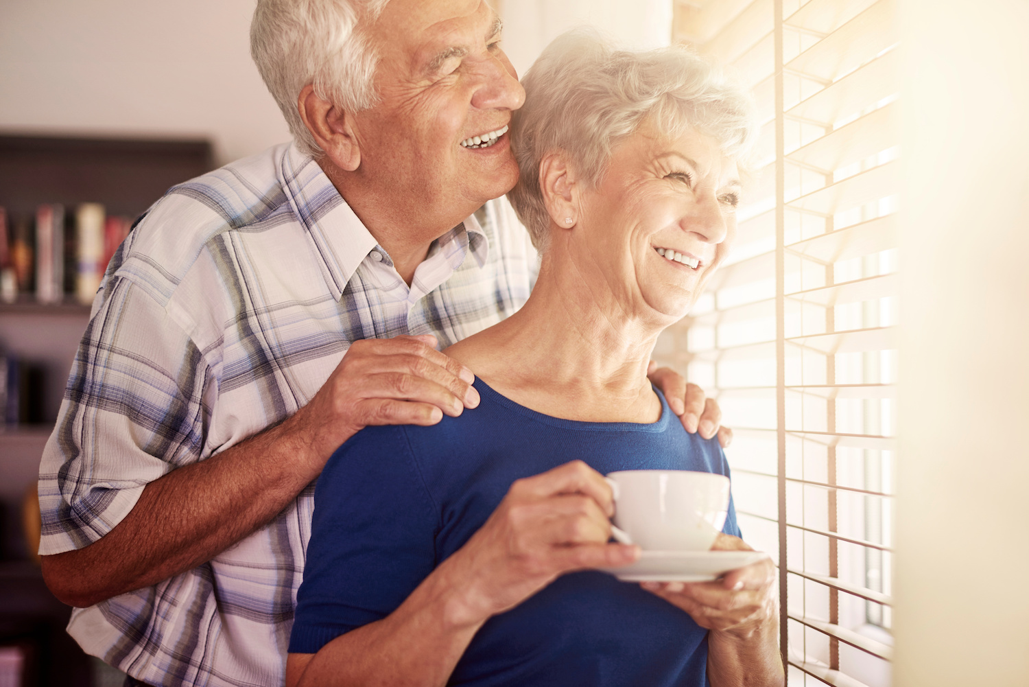 Senior couple looking out the window