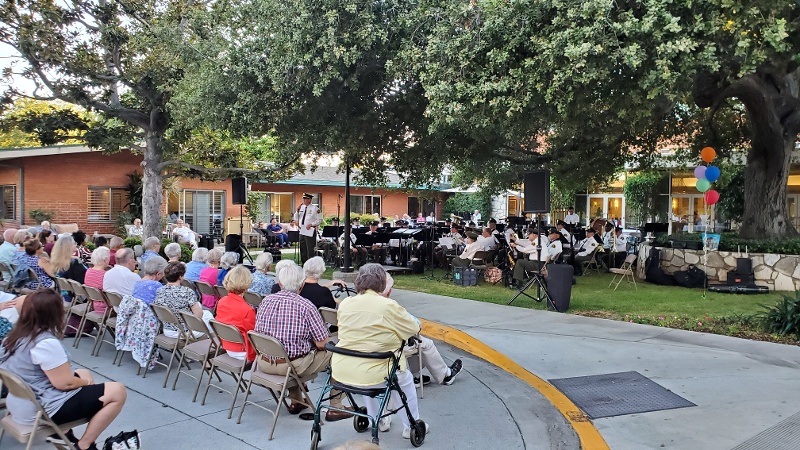Royal Oaks residents watching an outdoor concert.