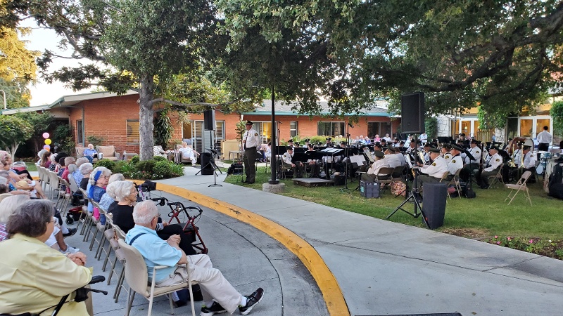 Royal Oaks residents watching an outdoor concert.