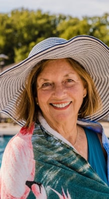 Woman standing next to a pool