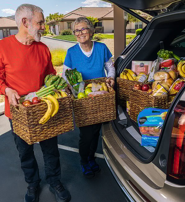 Brent and Karen loading up food in a car trunk