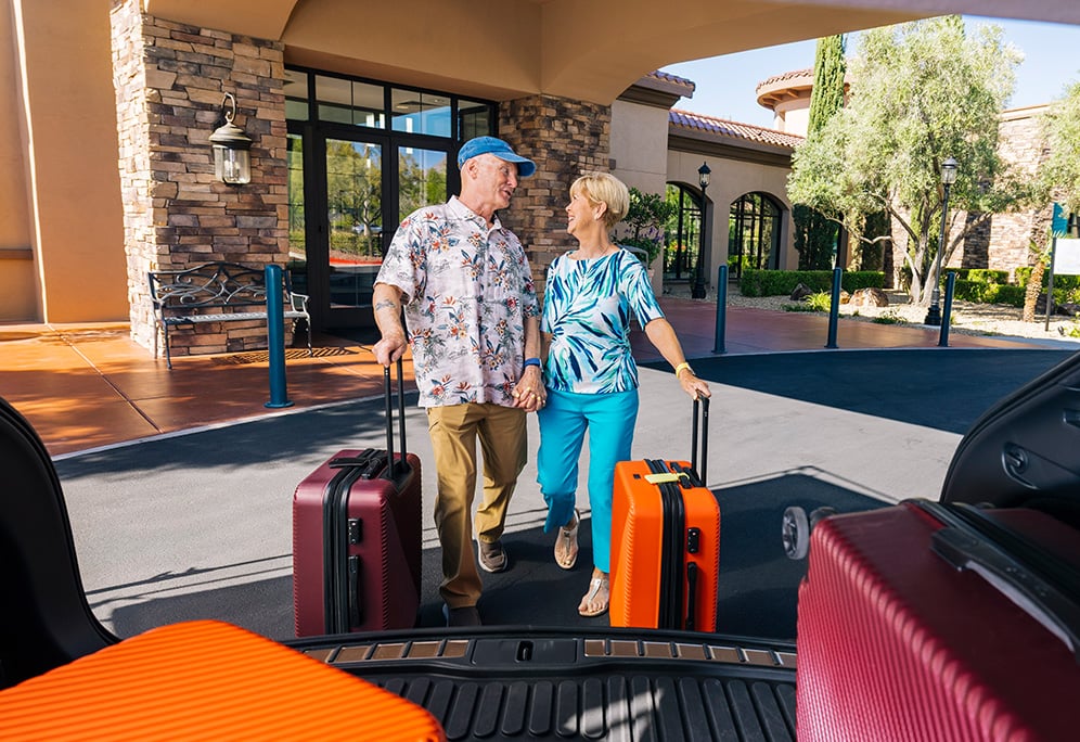Kevin and Kim with their suitcases about to embark on travel