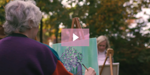 Senior women painting outside