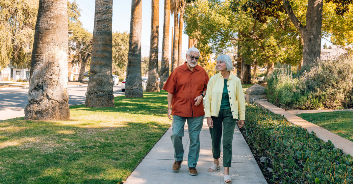 senior couple walking side by side outside