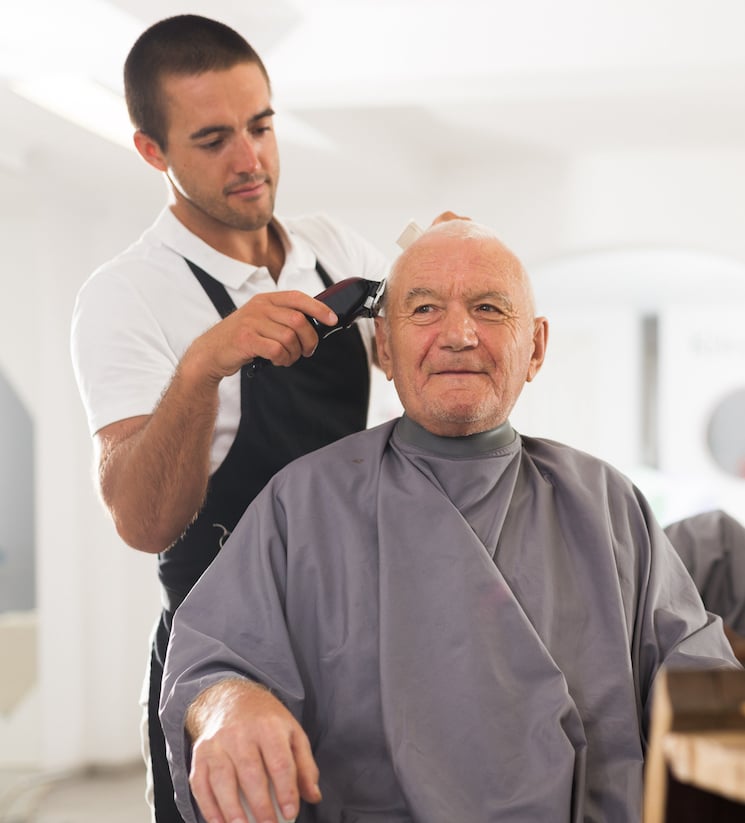 senior man getting a haircut